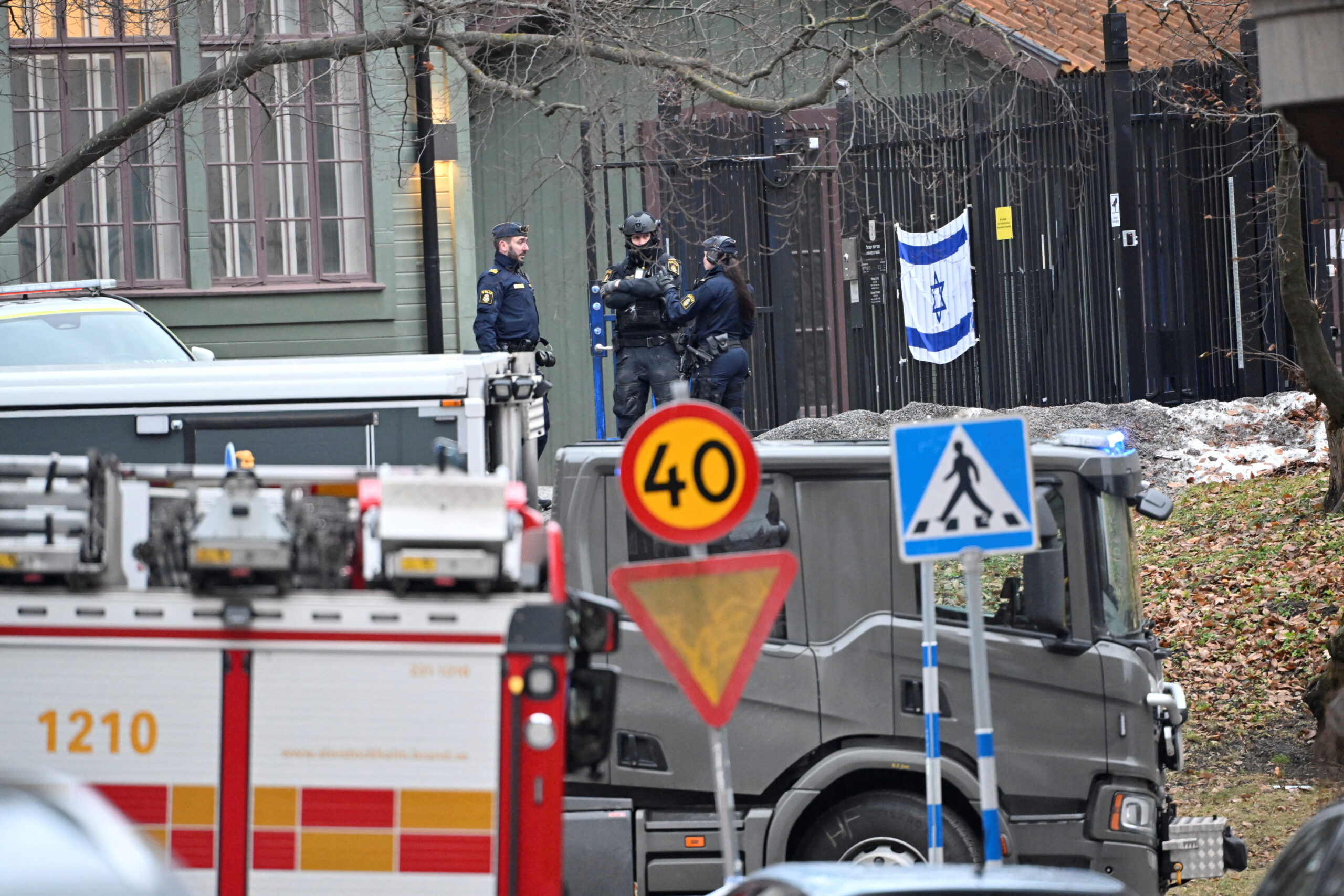 Emergency workers stand near the Israeli embassy in Stockholm